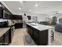 Open kitchen features granite countertops, stainless steel appliances, and an island with seating at 1237 E Paul Dr, Casa Grande, AZ 85122