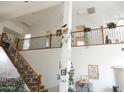 Bright open foyer with staircase, wrought iron railings, high ceilings and views of the second story at 15507 W Marconi Ave, Surprise, AZ 85374