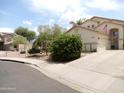 Charming single-story home features desert landscaping, a spacious driveway, and a neutral-toned facade at 15507 W Marconi Ave, Surprise, AZ 85374