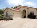 Inviting single-story home with a well-maintained yard, desert landscaping, and neutral stucco exterior at 15507 W Marconi Ave, Surprise, AZ 85374
