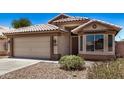 Charming single-story home with a two-car garage, desert landscaping, and decorative window at 16120 N 86Th Ln, Peoria, AZ 85382