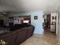 Spacious living room with an open floor plan, tile floors, and a brick fireplace at 1630 E Greenway St, Mesa, AZ 85203
