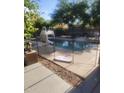 Sparkling fenced in pool featuring a ladder and lush landscaping at 1725 E Coconino Dr, Chandler, AZ 85249