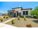 Inviting home showcasing desert landscaping, decorative stone accents, and a well-maintained walkway at 17376 W Wildwood St, Surprise, AZ 85388