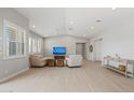 Airy living area features hardwood floors, neutral walls, vaulted ceiling, plantation shutters, and recessed lighting at 17376 W Wildwood St, Surprise, AZ 85388