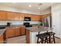 Well-equipped kitchen with modern appliances, ample cabinet space, and a central island at 17802 N 114Th Ln, Surprise, AZ 85378