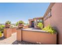 Inviting home entrance with a brick pathway and manicured plants and desert landscaping at 1809 E Adelante Way, Queen Creek, AZ 85140