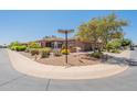 Corner lot home with desert landscaping and a view of the home's covered front entrance at 1809 E Adelante Way, Queen Creek, AZ 85140
