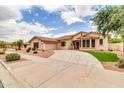 Inviting home boasts a circular driveway, tile roof, and desert-friendly landscaping at 20423 S 186Th St, Queen Creek, AZ 85142