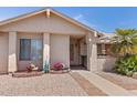 Close up of front exterior featuring decorative flower gardens and a covered front entryway at 2363 Leisure World --, Mesa, AZ 85206