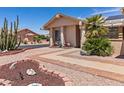 Attractive home exterior with desert landscaping, front flower garden, and a paved walkway at 2363 Leisure World --, Mesa, AZ 85206