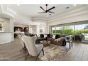 Expansive living room features stylish furnishings, a modern ceiling fan and sliding glass doors to the outside at 2821 E Cashman Dr, Phoenix, AZ 85050