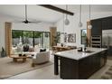 Bright, open-concept living space with modern decor, a dining area, and sliding glass doors to the backyard at 2916 E Sells Dr, Phoenix, AZ 85016