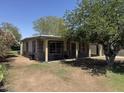 Single story home featuring desert landscaping, small covered porch, and neutral paint scheme at 3112 W Taylor St, Phoenix, AZ 85009