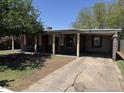 Single story home with drought tolerant landscaping and long covered parking area at 3112 W Taylor St, Phoenix, AZ 85009