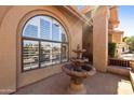 Exterior view featuring a water fountain, an arched window and a brick walkway at 3538 E Squawbush Pl, Phoenix, AZ 85044