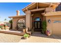 Inviting front entrance with decorative fountains, an arched window and a warm, welcoming feel at 3538 E Squawbush Pl, Phoenix, AZ 85044