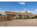 Single-story home with a covered carport, neutral exterior, and minimalist landscaping at 3632 W Mariposa St, Phoenix, AZ 85019