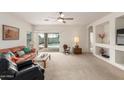 Bright living room with sliding glass doors that offer pool views and ample natural light at 3724 E Derringer Way, Gilbert, AZ 85297
