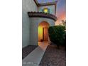 Inviting entryway with an arched doorway, neutral paint, and well-maintained landscaping at 4038 E Wagon Cir, Gilbert, AZ 85297
