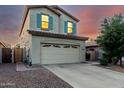 Charming two-story home with a two-car garage, desert landscaping, and inviting curb appeal at sunset at 4038 E Wagon Cir, Gilbert, AZ 85297