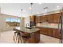 Gourmet kitchen featuring granite counters, central island, and modern appliances at 41627 N Cedar Chase Rd, Anthem, AZ 85086