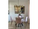Cozy dining area with a glass table, comfortable seating, and modern lighting, perfect for meals at 4540 N 35Th N Ave, Phoenix, AZ 85017