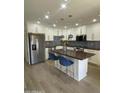Modern kitchen featuring white cabinetry, stainless steel appliances, and a stylish island with seating at 4540 N 35Th N Ave, Phoenix, AZ 85017