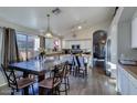 Spacious kitchen features stainless appliances, white cabinets, and an adjacent dining area at 4605 W Fawn Dr, Laveen, AZ 85339