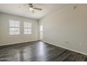 Bright living room with dark wood floors, ceiling fan and neutral paint at 5302 E Van Buren St # 3040, Phoenix, AZ 85008