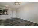 Well-lit living room featuring an open floor plan, ceiling fan, and wood floors at 5302 E Van Buren St # 3040, Phoenix, AZ 85008