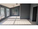 Spacious living room with large windows, tiled floors, and a ceiling fan, providing ample natural light at 537 E Piute Ave, Phoenix, AZ 85024