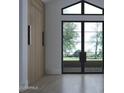Bright entryway featuring a large window with natural light and contemporary wood door at 5636 E Caballo Dr, Paradise Valley, AZ 85253