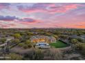 Expansive desert home featuring a private pool, outdoor seating, artificial turf, and desert views at 7130 E Navarro Way, Scottsdale, AZ 85266