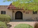 Charming brick home with a covered front entry and a striking, arched doorway at 7232 N 22 Nd St, Phoenix, AZ 85020