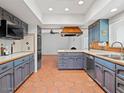 Galley kitchen with blue cabinets, tile floors and stainless steel appliances at 7232 N 22 Nd St, Phoenix, AZ 85020