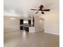 Open concept living area with tile floors, a ceiling fan, and a view of the kitchen at 737 E Harwell Rd, Phoenix, AZ 85042