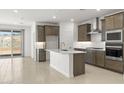 Modern kitchen with stainless steel appliances, subway tile backsplash and an island at 7428 W Buckhorn Trl, Peoria, AZ 85383