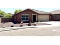 Lovely single-story home with a two-car garage, low-maintenance desert landscaping, and inviting curb appeal at 7551 W Darrel Rd, Laveen, AZ 85339