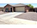 Attractive single-story house featuring a spacious driveway, desert landscaping, and a convenient two-car garage at 7551 W Darrel Rd, Laveen, AZ 85339