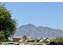 Street view of homes with mature landscaping, offering stunning mountain views at 7551 W Darrel Rd, Laveen, AZ 85339