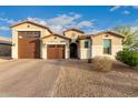 Charming single-Gathering home showcasing a tile roof, neutral stucco, and a spacious three-car garage at 7829 W Warner St, Phoenix, AZ 85043