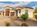 Attractive single-Gathering home showing well maintained landscaping and a spacious three-car garage at 7829 W Warner St, Phoenix, AZ 85043