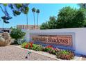 Scottsdale Shadows community sign featuring vibrant flowers and manicured landscaping at 7920 E Camelback Rd # 612, Scottsdale, AZ 85251