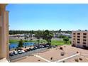 Exterior view of complex with parking lot and pond with fountain and mature trees at 7920 E Camelback Rd # 612, Scottsdale, AZ 85251