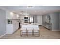 Spacious eat-in kitchen featuring white cabinets, stainless steel appliances, and an island with seating at 7920 E Camelback Rd # 612, Scottsdale, AZ 85251