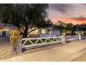 Exterior showcasing a quaint yard and a classic white fence, blending charm with inviting curb appeal at 8021 N 16Th Dr, Phoenix, AZ 85021
