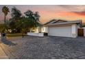 Spacious driveway leading to a home with a large garage, complemented by a well-maintained yard and desert landscaping at 8021 N 16Th Dr, Phoenix, AZ 85021