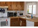Functional kitchen with ample cabinet space, essential appliances, and a window over the sink at 8802 W Cinnabar Ave, Peoria, AZ 85345