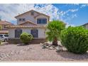 Charming home with rock landscaping, a tile roof, dark brown shutters, and a covered entry at 941 W Dexter Way, San Tan Valley, AZ 85143